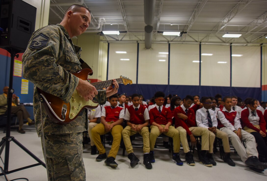 Max Impact guitarist performs for students