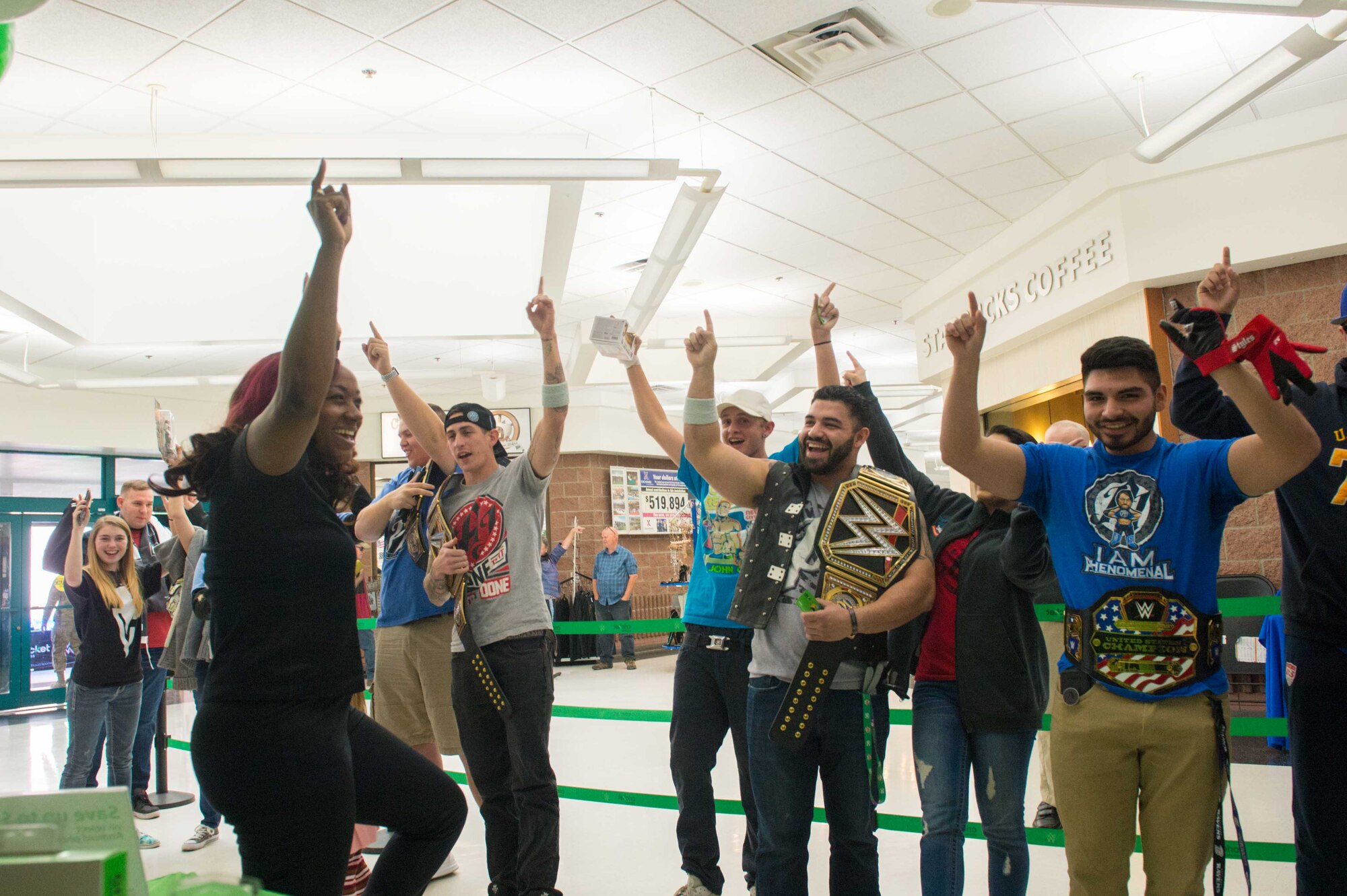 Members from Team Luke cheer for AJ Styles, World Wrestling Entertainment professional athlete, before a meet-and-greet event at Luke Air Force Base, Ariz., Feb. 20, 2018. Airmen brought various items and memorabilia for Styles to autograph during the event. (U.S. Air Force photo/Airman 1st Class Caleb Worpel)