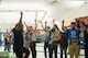 Members from Team Luke cheer for AJ Styles, World Wrestling Entertainment professional athlete, before a meet-and-greet event at Luke Air Force Base, Ariz., Feb. 20, 2018. Airmen brought various items and memorabilia for Styles to autograph during the event. (U.S. Air Force photo/Airman 1st Class Caleb Worpel)