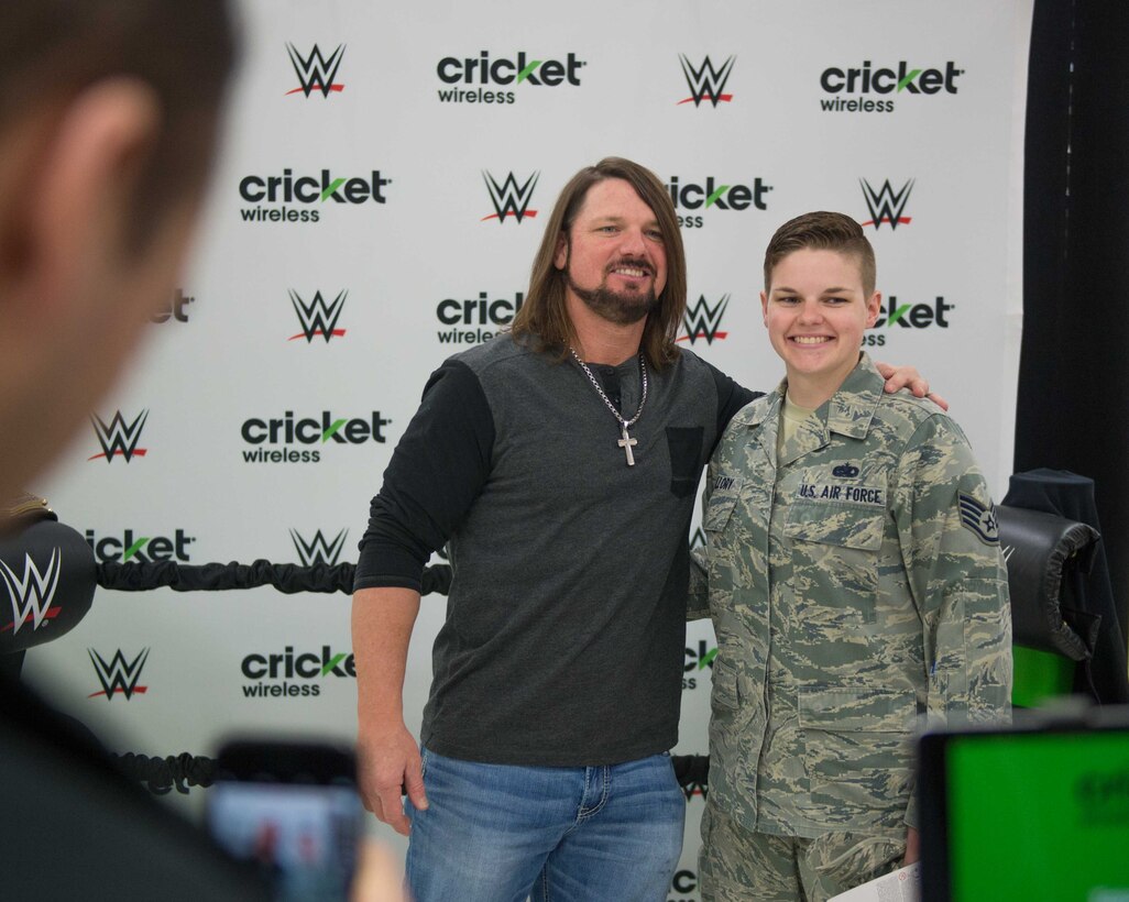 Staff Sgt. Cassandra Mallory, 56th Fighter Wing drug demand reduction team member, poses for a photo with AJ Styles, World Wrestling Entertainment professional athlete, at Luke Air Force Base, Ariz., Feb. 20, 2018. Airmen and other visitors with base access had the opportunity to take photos, receive autographs and interact with Styles during the event. (U.S. Air Force photo/Airman 1st Class Caleb Worpel)