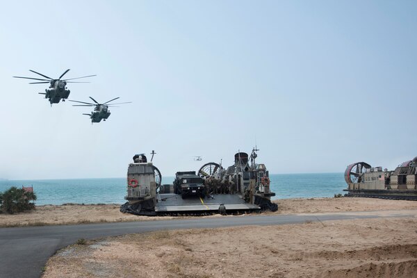 Two Marine Corps CH-53E Super Stallion helicopters fly over during an amphibious assault.