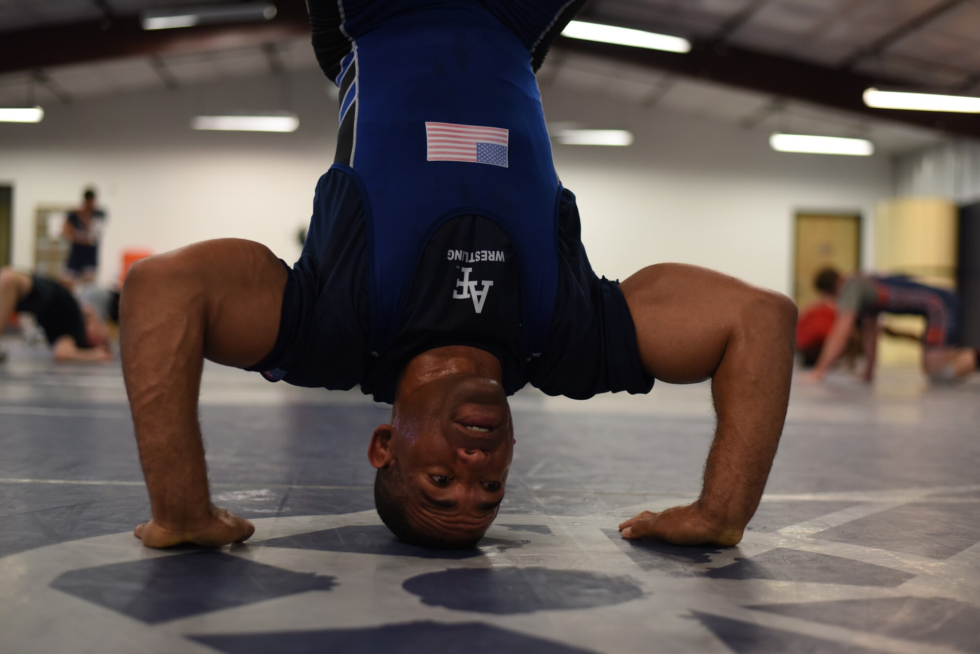Master Sgt. Sherwin Severin stretches his neck during wrestling practice at the U.S. Air Force Wrestling Team training camp at Joint Base McGuire-Dix-Lakehurst, N.J., Feb. 19, 2018. Severin will compete in the Armed Forces Championship at Marine Corps Base Camp Lejeune, N.C. (U.S. Air Force photo by Airman 1st Class Zachary Martyn)