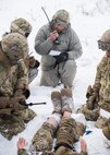 Members of the 91st Security Forces Group, Minot Air Force Base, North Dakota, perform first aid on a simulated casualty in the Turtle Mountain State Forest, North Dakota, Feb. 14, 2018. After stabilizing the casualty, defenders vectored in a rescue helicopter for an emergency medical evacuation. (U.S. Air Force photo by Senior Airman J.T. Armstrong)