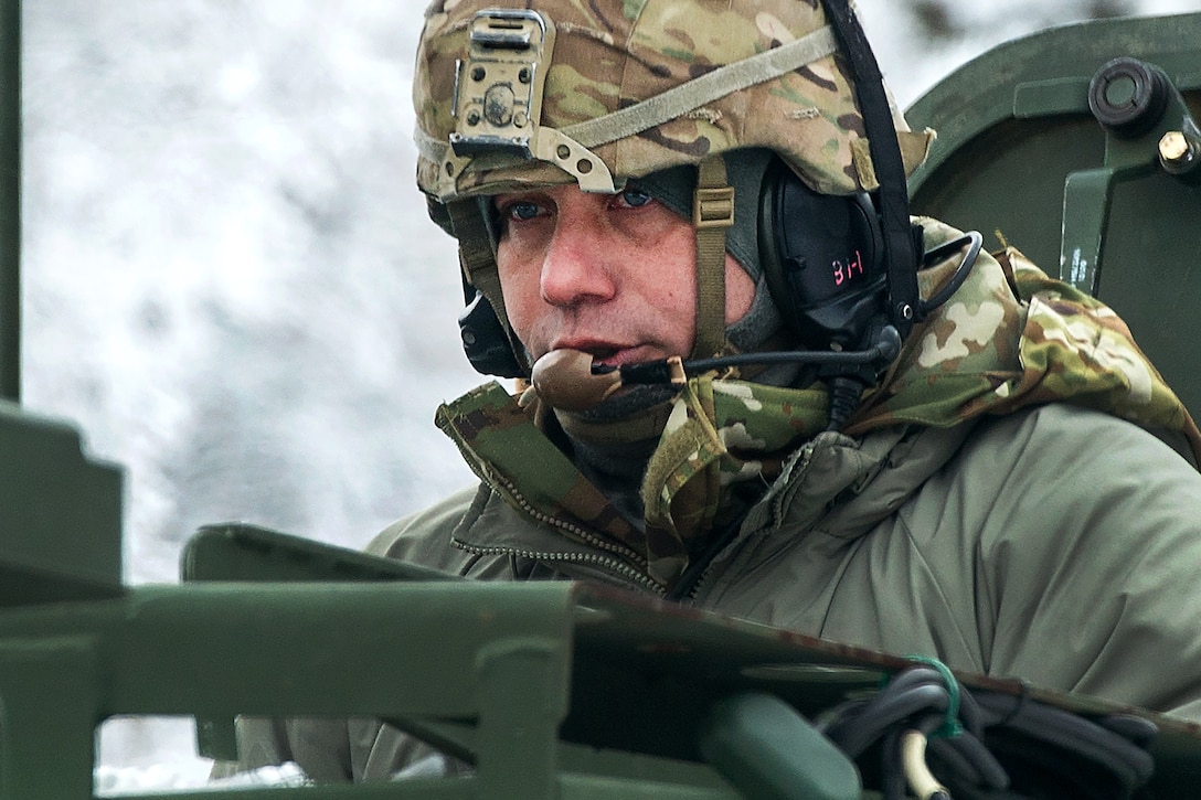 A soldier talks into a headset.