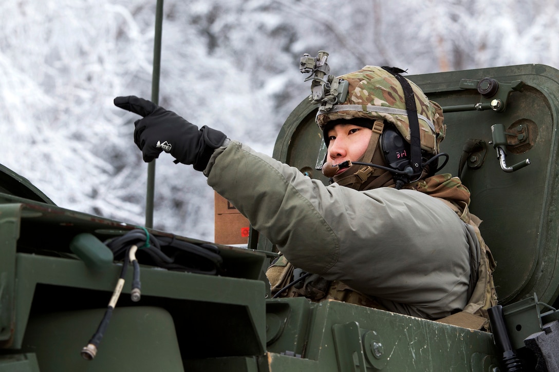 Army 1st Lt. Daniel Choi directs his Stryker armored vehicle while preparing for live-fire gunnery.