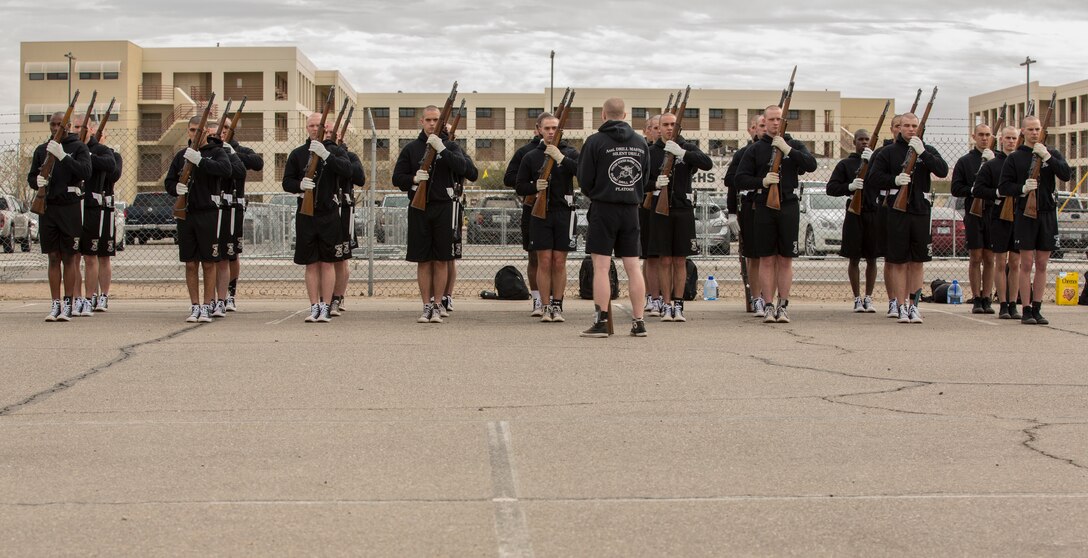 U.S. Marines with the Marine Corps Silent Drill Platoon conduct practice at Marine Corps Air Station Yuma, Ariz., Feb. 13, 2018 to prepare for their West Coast tour. The Marine Corps Silent Drill Platoon is apart of The Battle Color Detachment along with "The Commandants Own" U.S. Marine Corps Drum & Bugle Corps and The Official Color Guard of the Marine Corps. (U.S. Marine Corps photo by Lance Cpl. Sabrina Candiaflores)