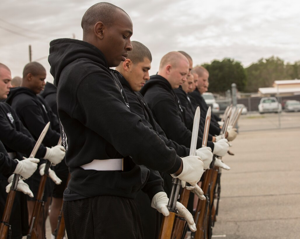 U.S. Marines with the Marine Corps Silent Drill Platoon conduct practice at Marine Corps Air Station Yuma, Ariz., Feb. 13, 2018 to prepare for their West Coast tour. The Marine Corps Silent Drill Platoon is apart of The Battle Color Detachment along with "The Commandants Own" U.S. Marine Corps Drum & Bugle Corps and The Official Color Guard of the Marine Corps. (U.S. Marine Corps photo by Lance Cpl. Sabrina Candiaflores)