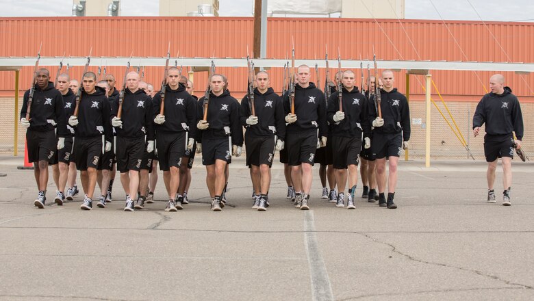 U.S. Marines with the Marine Corps Silent Drill Platoon conduct practice at Marine Corps Air Station Yuma, Ariz., Feb. 13, 2018 to prepare for their West Coast tour. The Marine Corps Silent Drill Platoon is apart of The Battle Color Detachment along with "The Commandants Own" U.S. Marine Corps Drum & Bugle Corps and The Official Color Guard of the Marine Corps. (U.S. Marine Corps photo by Lance Cpl. Sabrina Candiaflores)