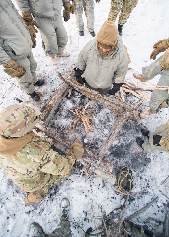 Airmen build a fire during a three-day field training exercise in the Turtle Mountain State Forest, N.D.