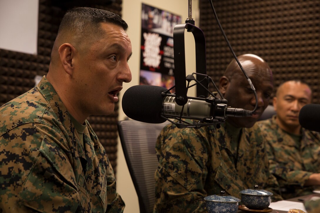 Sgt. Maj. Mario Marquez, the III Marine Expeditionary Force sergeant major, talks about what it means to be a III MEF Marine during a radio show at American Forces Network, Okinawa, Japan, Feb. 21, 2018. Marquez, Sgt. Maj. Ronald Green, the sergeant major of the Marine Corps, and Sgt. Maj. Peter Siaw, the Marine Corps Installations Pacific sergeant major, talked to the AFN Pacific audience about changes in the Marine Corps. “No other place where families are stationed, that I know of, has missiles being launched over it,” said Marquez. “Whether in anger or not, we are in the fight. III MEF Marines are in the fight.” (U.S. Marine Corps photo by Pfc. Hannah Hall)
