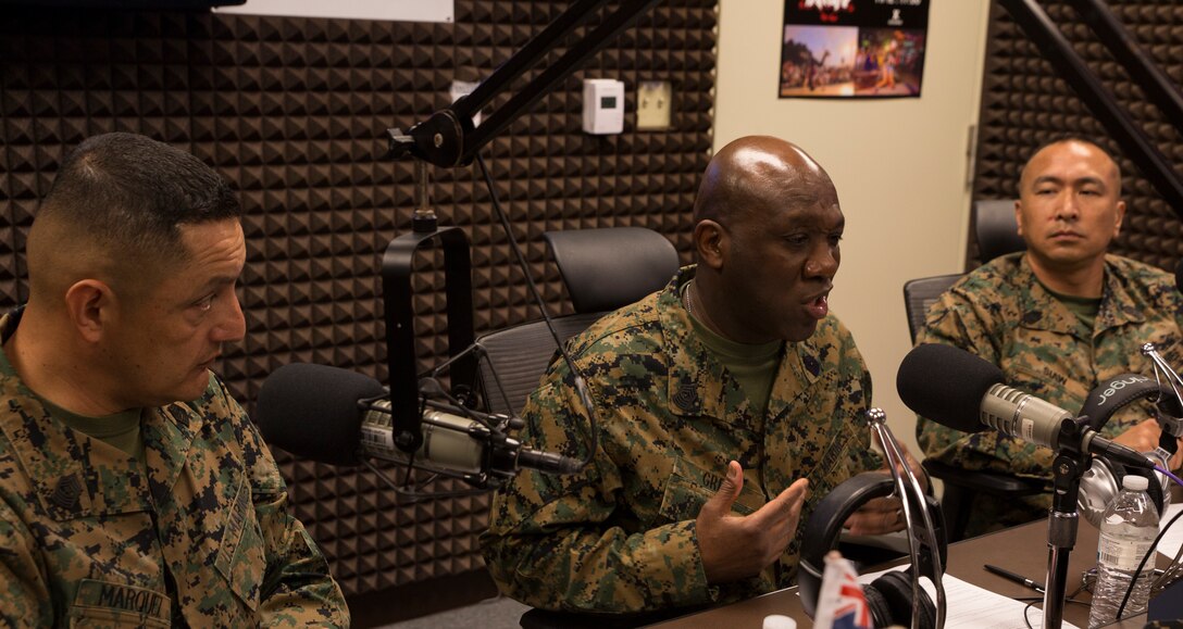 Sgt. Maj. Ronald Green, sergeant major of the Marine Corps discusses the 4th phase of recruit training during a radio show at American Forces Network, Okinawa, Japan, Feb. 21, 2018. Green, Sgt. Maj. Mario Marquez, the III Marine Expeditionary Force sergeant major, and Sgt. Maj. Peter Siaw, the Marine Corps Installations Pacific sergeant major, talked to the AFN Pacific audience about changes in the Marine Corps (U.S. Marine Corps photo by Pfc. Hannah Hall)