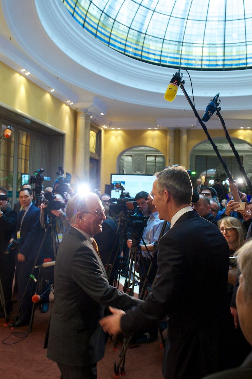 NATO Secretary General Jens Stoltenberg shakes hands with Wolfgang Ischinger, the chairman of the Munich Security Conference, in Munich, Feb. 16, 2018. NATO photo