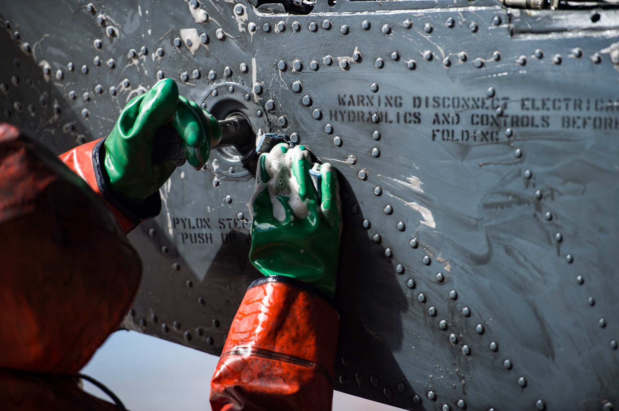 An Airman from the 41st Helicopter Maintenance Unit washes an HH-60G Pave Hawk, Feb. 20, 2018, at Moody Air Force Base, Ga. Airmen are required to wash the helicopters every 180 days to control corrosion caused by oil, dirt and grime. Washing paired with mechanical and electrical maintenance help Airmen ensure the Pave Hawks are ready at a moment’s notice. (U.S. Air Force photo by Senior Airman Janiqua P. Robinson)