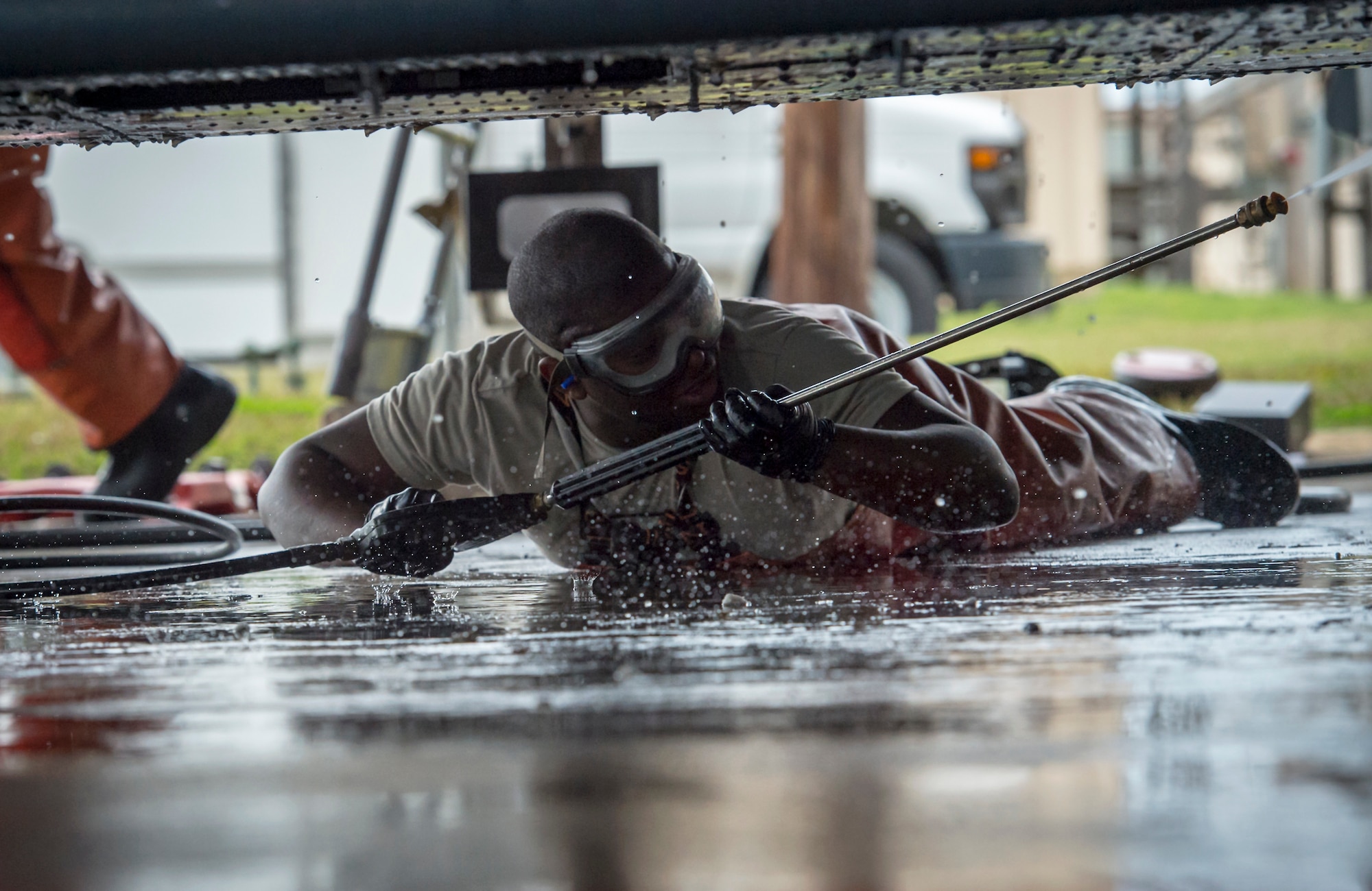 Airman 1st Class Omar Harris, 41st Helicopter Maintenance Unit crew chief, sprays the bottom of an HH-60G Pave Hawk, Feb. 20, 2018, at Moody Air Force Base, Ga. Airmen are required to wash the helicopters every 180 days to control corrosion caused by oil, dirt and grime. Washing paired with mechanical and electrical maintenance help Airmen ensure the Pave Hawks are ready at a moment’s notice. (U.S. Air Force photo by Senior Airman Janiqua P. Robinson)