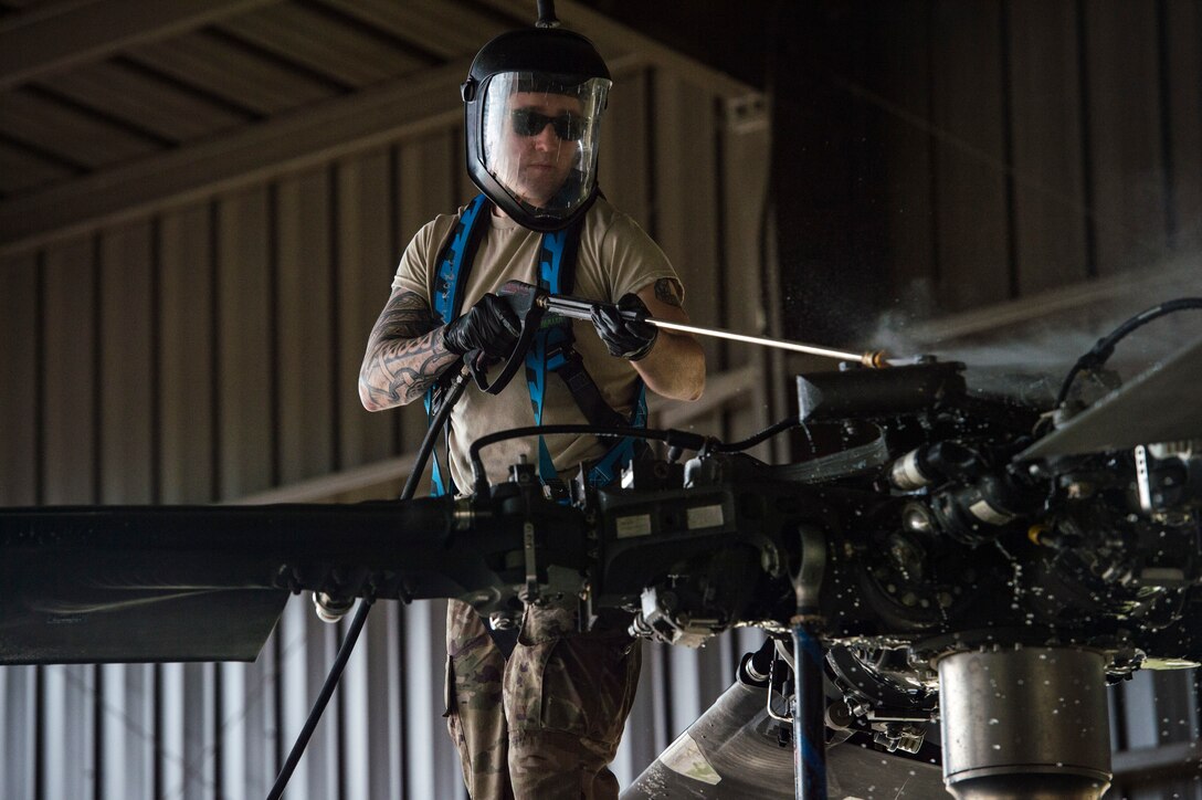 Senior Airman Matthew Bendall, 41st Helicopter Maintenance Unit communication and navigation journeyman, sprays the top of an HH-60G Pave Hawk, Feb. 22, 2018, at Moody Air Force Base, Ga. Airmen are required to wash the helicopters every 180 days to control corrosion caused by oil, dirt and grime. Washing paired with mechanical and electrical maintenance help Airmen ensure the Pave Hawks are ready at a moment’s notice. (U.S. Air Force photo by Senior Airman Janiqua P. Robinson)