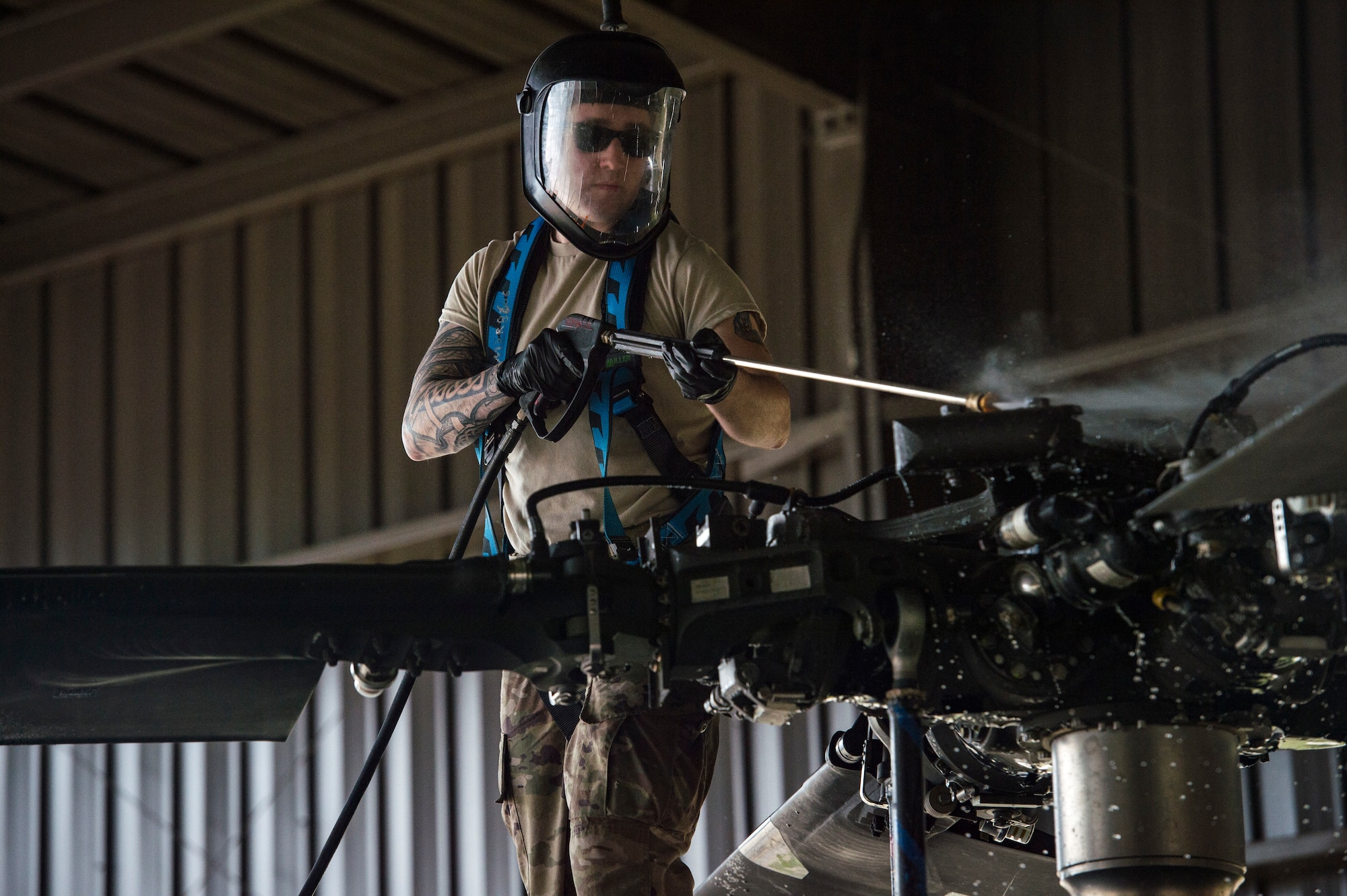 Senior Airman Matthew Bendall, 41st Helicopter Maintenance Unit communication and navigation journeyman, sprays the top of an HH-60G Pave Hawk, Feb. 22, 2018, at Moody Air Force Base, Ga. Airmen are required to wash the helicopters every 180 days to control corrosion caused by oil, dirt and grime. Washing paired with mechanical and electrical maintenance help Airmen ensure the Pave Hawks are ready at a moment’s notice. (U.S. Air Force photo by Senior Airman Janiqua P. Robinson)