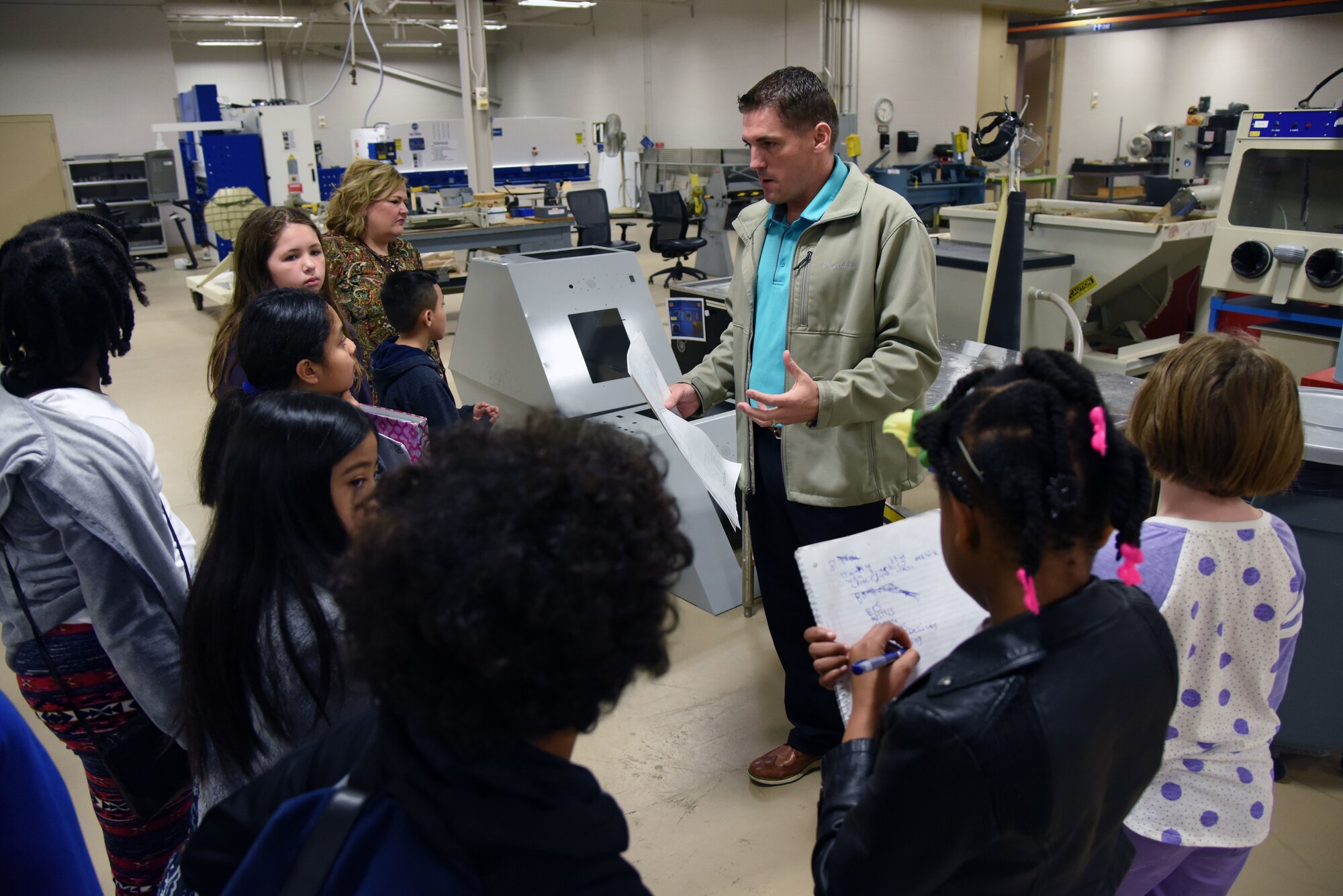 Tomme Lassabe, 81st Training Support Squadron training technology flight chief, briefs Biloxi school students on the Trainer Development Center capabilities during Biloxi Career Exploration Day Feb. 14, 2018, on Keesler Air Force Base, Mississippi. The school-aged children also toured the 334th Training Squadron, 335th TRS and the Keesler Fire Department. (U.S. Air Force photo by Kemberly Groue)