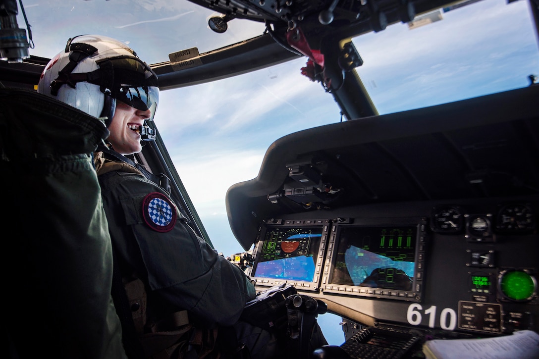 Navy Lt. j.g. Sarah Alexandre co-pilots an MH-60S Sea Hawk helicopter during a search and rescue exercise.