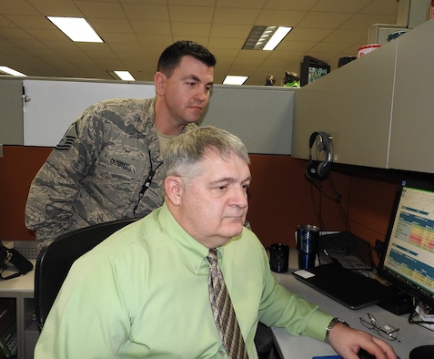 Mark Davis and MSgt Richard Duvall from the AFIMSC Installation Support Directorate Integrated Defense Integration Cell, look at data gathered for analysis.  He has been selected as the 2017 Air Force Outstanding Security Forces Higher Headquarters Civilian of the Year.  Davis is part of a think-tank initiative that takes problems and analyzes data to provide courses of action in innovative ways.