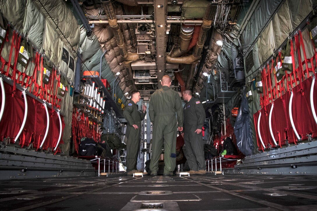 Airmen prepare to fly on a C-130H Hercules aircraft.