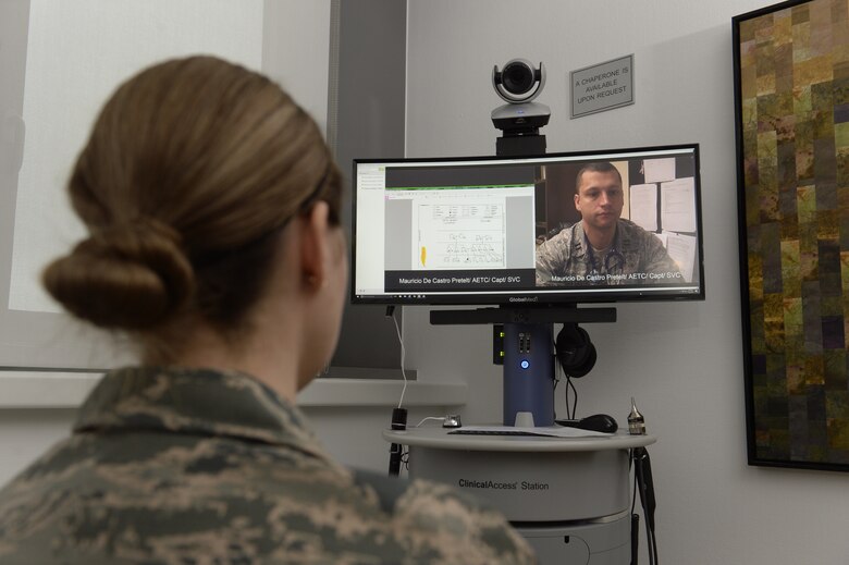 Senior Airman Kimberly Deveau (left) at Spangdahlem Air Base, Germany consults with geneticist, Capt. (Dr.) Mauricio De Castro, staff medical geneticist at Keesler Air Force Base, Miss., using the Clinical Access Station, Feb. 1, 2018. The tele-genetics pilot program connects patients directly to specialized genetic counselors and geneticists from other locations. (U.S. Air Force photo by Staff Sgt. Jonathan Snyder)