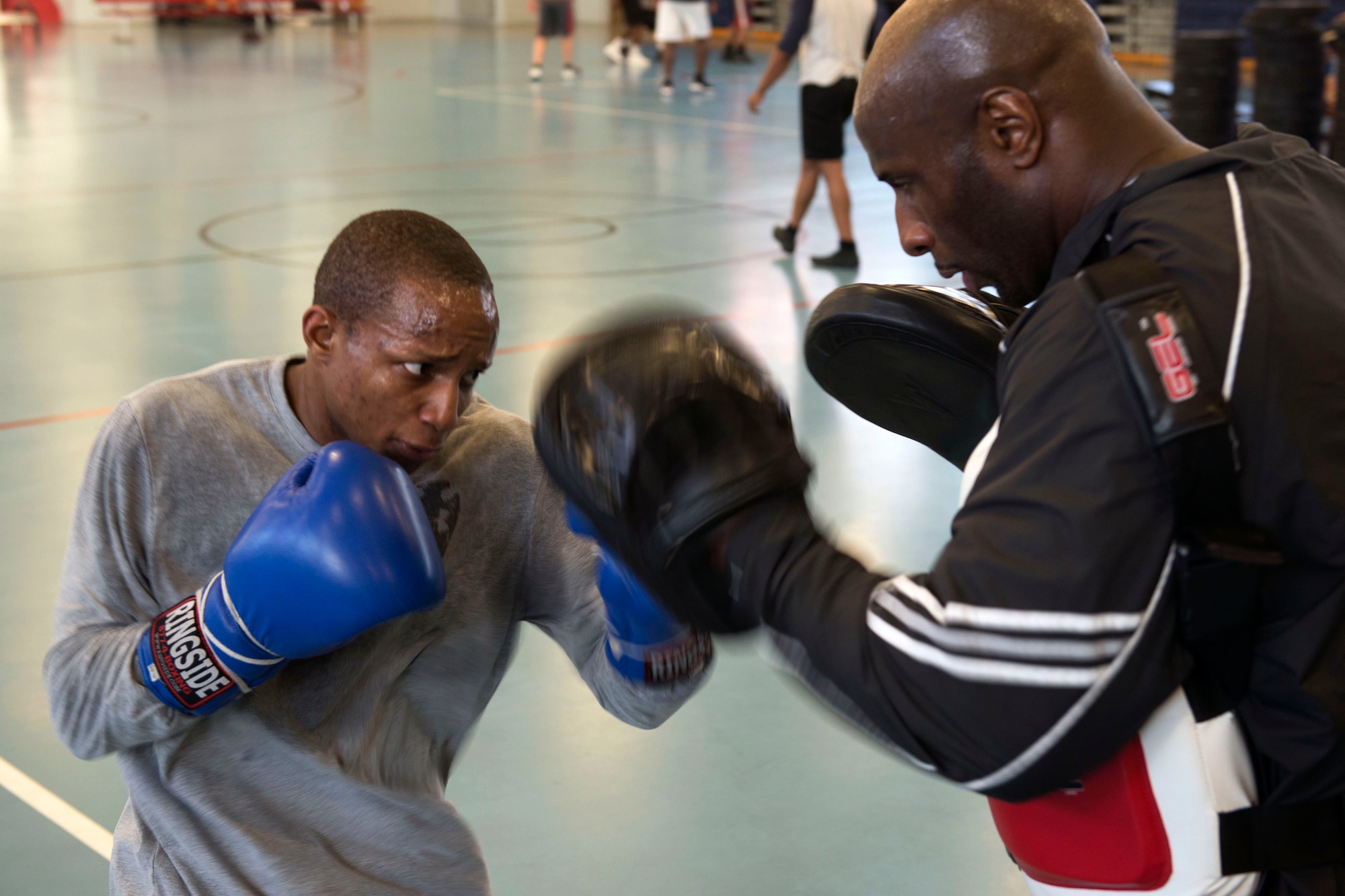 U.S. Army Sgt. 1st Class Andrew Shepherd, battalion supply noncommissioned officer in charge, 1st Battalion, 222nd Regiment, 128th Brigade, spars with U.S. Army Sgt. Darius Lane, helicopter repairer, Detachment 2, B Company, 935th Aviation Support Battalion, in Joint Base Langley-Eustis' Anderson Field House at Fort Eustis, Va., Feb. 15, 2018. Training for competitions includes maintaining weight through proper physical conditioning and diet. (U.S. Air Force photo by Airman 1st Class Monica Roybal)