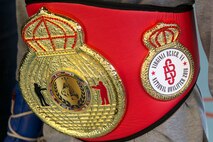 U.S. Army Sgt. Darius Lane, helicopter repairer, Detachment 2, B Company, 935th Aviation Support Battalion, wears the 2018 Sugar Belt Boxing National Qualifier tournament belt in Joint Base Langley-Eustis' Anderson Field House at Fort Eustis, Va., Feb. 15, 2018. Hundreds of boxers competed for the belt and a chance to compete in the regional tournament. (U.S. Air Force photo by Airman 1st Class Monica Roybal)