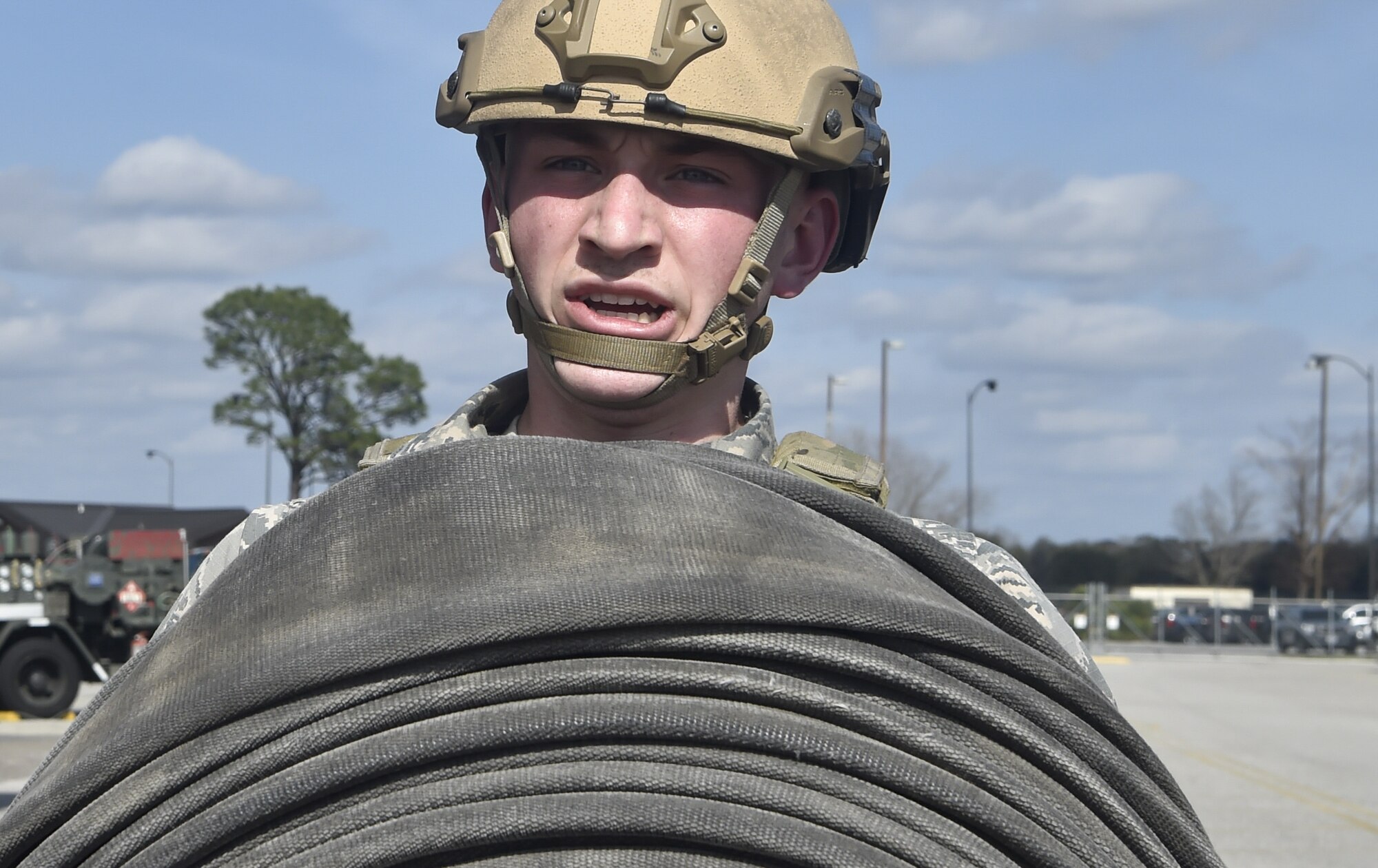 Airman 1st Class Nathan Lynch, 628th Logistics Readiness Squadron fuels distribution operator, carries a fire hose as part of a tryout for the Forward Area Refueling Point team here Feb. 15, 2018.