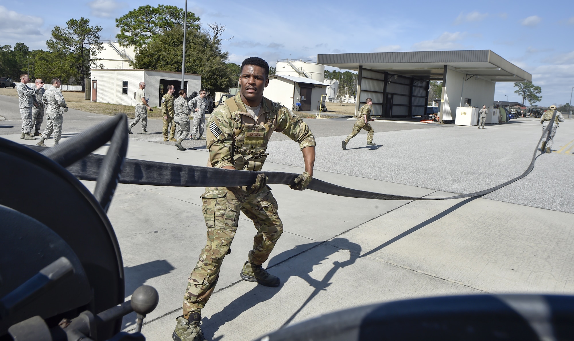 Senior Airman Cortland Carson, 628th Logistics Readiness Squadron fuels service center controller, unravels fuel hose during a Forward Area Refueling Point team tryout Feb. 15, 2018.