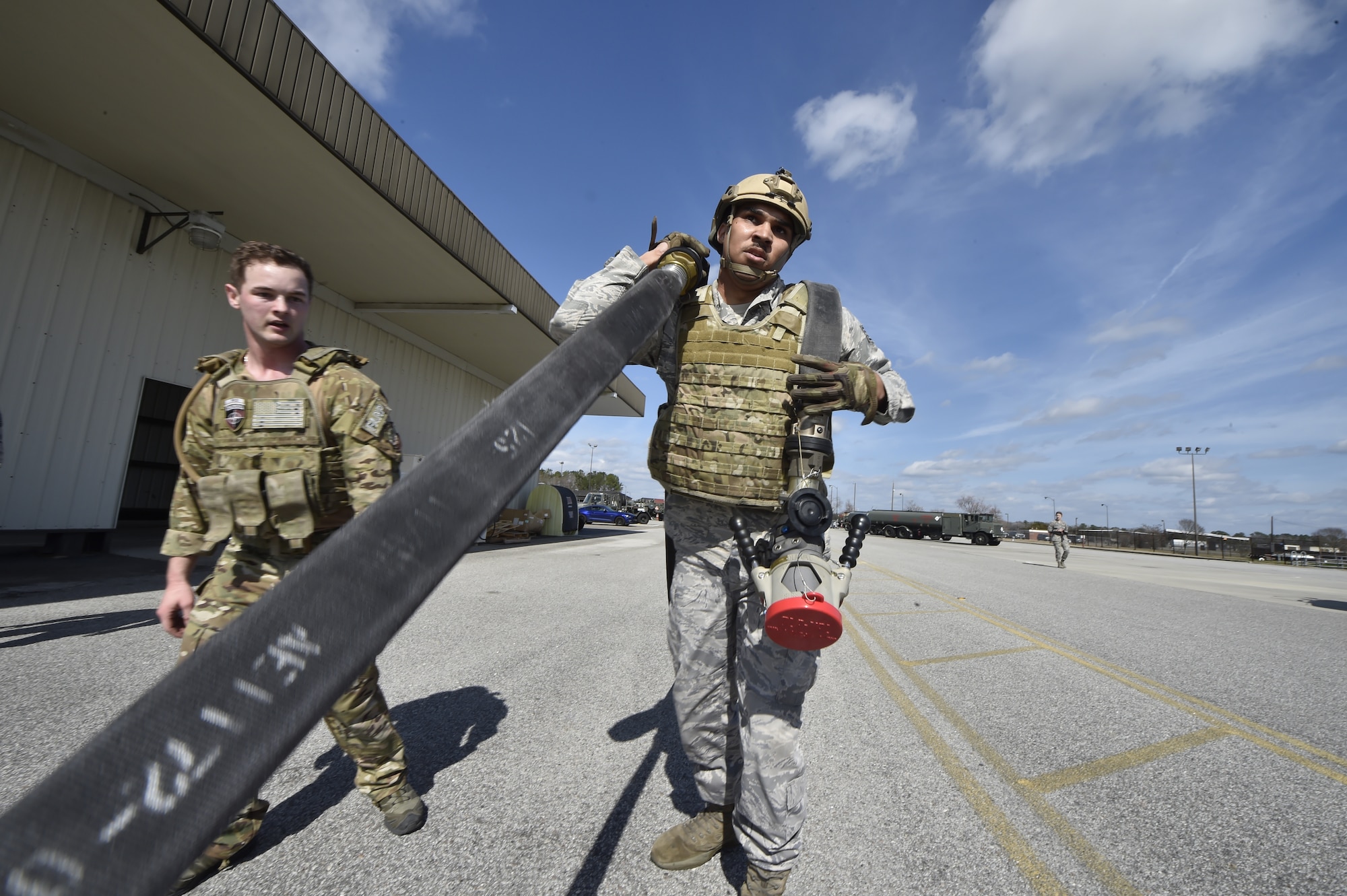 Staff Sgt. Eddie Flint, 628th Logistics Readiness Squadron fuels distribution supervisor carries a hose during a Forward Area Refueling Point team tryout here Feb. 15, 2018.