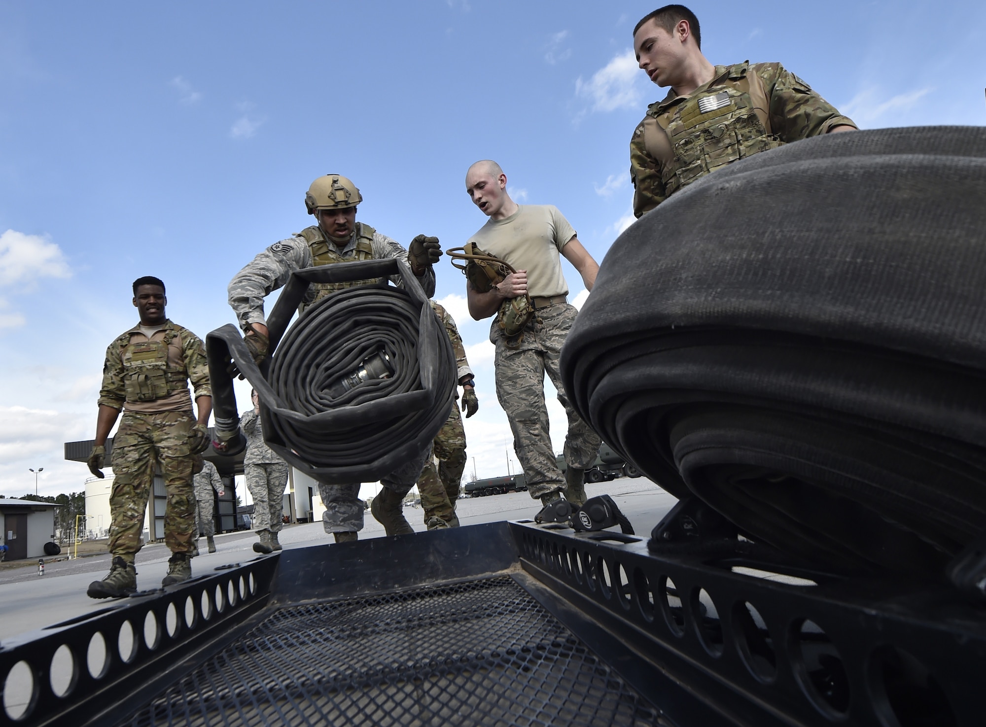 Staff Sgt. Eddie Flint, 628th Logistics Readiness Squadron fuels distribution supervisor puts away a hose during a Forward Area Refueling Point team tryout here Feb. 15, 2018.