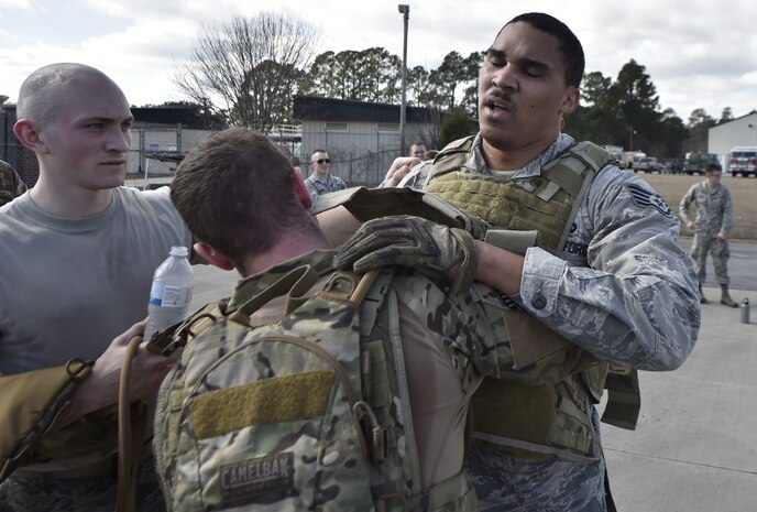 Staff Sgt. Eddie Flint, right, 628th Logistics Readiness Squadron fuels distribution supervisor is congratulated by Senior Airman Christopher Stuebbe, center, 628th Logistics Readiness Squadron fuels distribution supervisor and Airman 1st Class Nathan Lynch, 628th Logistics Readiness Squadron fuels distribution operator, after finishing the Forward Area Refueling Point course here Feb. 15, 2018.