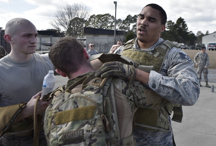 Staff Sgt. Eddie Flint, right, 628th Logistics Readiness Squadron fuels distribution supervisor is congratulated by Senior Airman Christopher Stuebbe, center, 628th Logistics Readiness Squadron fuels distribution supervisor and Airman 1st Class Nathan Lynch, 628th Logistics Readiness Squadron fuels distribution operator, after finishing the Forward Area Refueling Point course here Feb. 15, 2018.