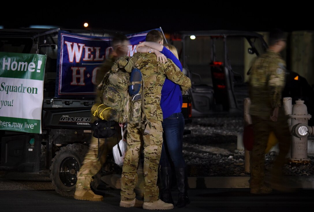 A member of the 66th Rescue Squadron is greeted by family after returning from deployment Feb. 8, 2018, at Nellis Air Force Base, Nevada. 66th RQS and 823rd MXS members were deployed for four months to support Operation Inherent Resolve. (U.S. Air Force photo by Airman 1st Class Andrew D. Sarver)