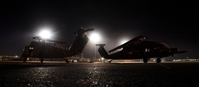 HH-60G Pave Hawk helicopters sit on the runway after being unloaded from a C-5M Super Galaxy Feb. 8, 2018, at Nellis Air Force Base, Nevada. The Pave Hawk is a highly modified version of the Army Black Hawk helicopter. (U.S. Air Force photo by Airman 1st Class Andrew D. Sarver)