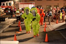 Firefighter and bioenvironmental teams suit up to enter the scene during an emergency response exercise Jan. 30, 2018, at Hill Air Force Base, Utah. (U.S. Air Force photo by Todd Cromar)