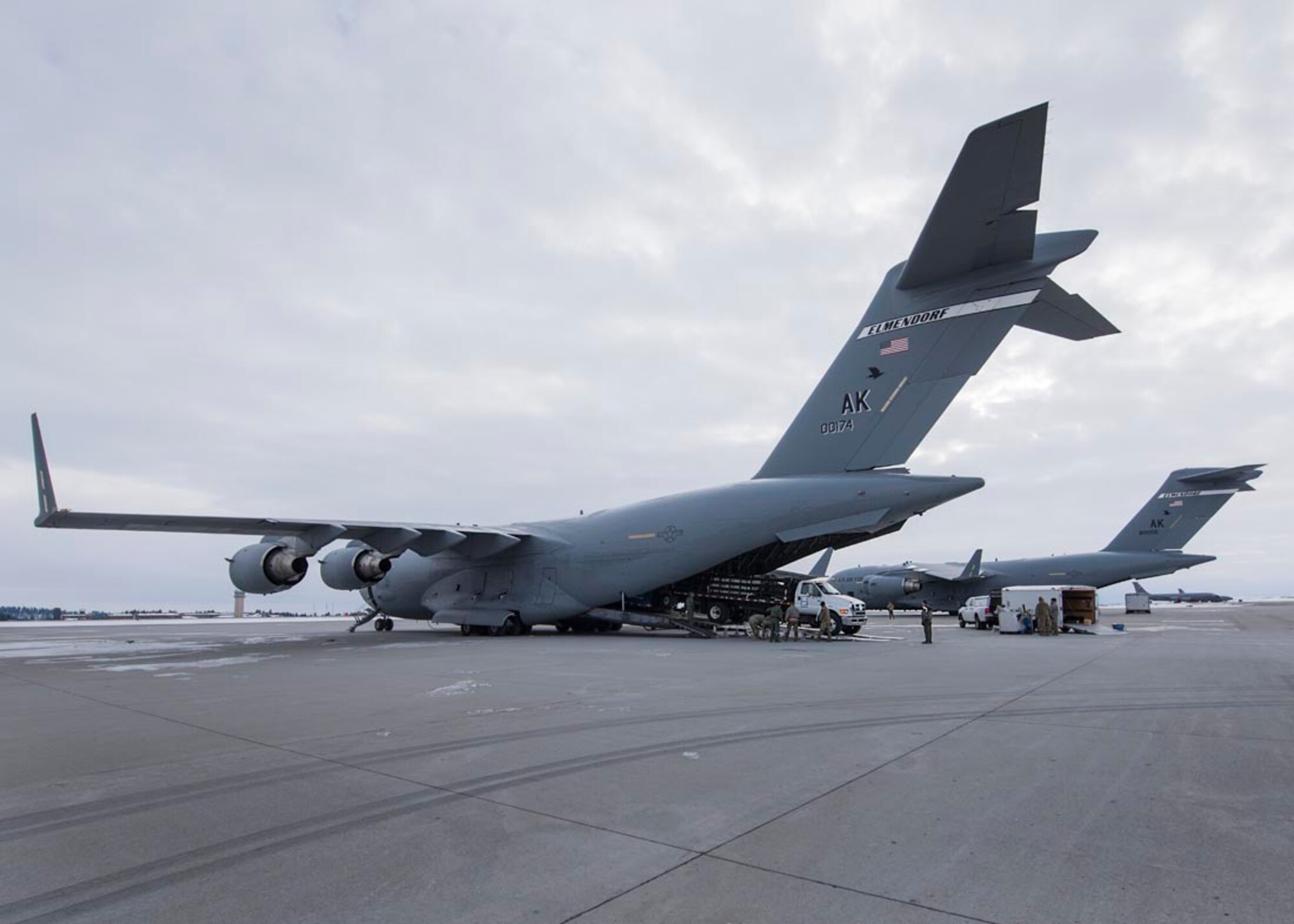 Guardsmen from the 141st Air Refueling Wing assist in loading equipment and vehicles onto two C-17 Globemaster III aircraft February 20, 2018 at Fairchild Air Force Base, Wash. Nearly 250 Air and Army Guardsmen from Alaska, Colorado, Connecticut, Indiana, South Dakota, Utah, and Washington are slated to participate in Exercise Arctic Eagle 2018 In Valdez, Alaska through the end of February. Arctic Eagle is a scenario-based exercise in which Guardsmen will conduct Homeland Response Force (HRF) and Chemical, Biological, Radiological, Nuclear and High Yield Explosive (CBRNE) Enhanced Response Force Package (CERFP) operations in a cold weather environment.  (U.S. Air National Guard photo by Staff Sgt. Rose M. Lust/Released)