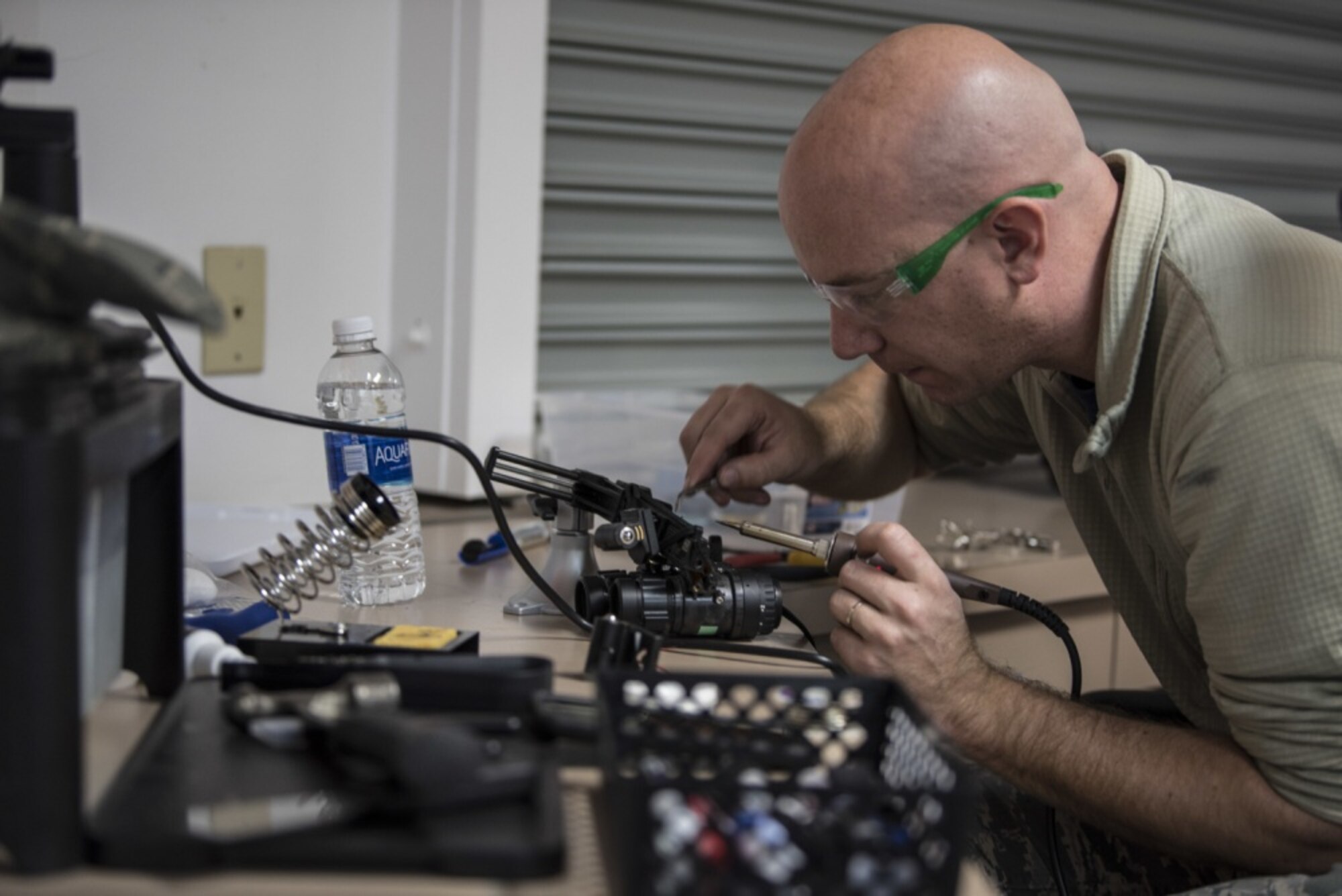 Tech Sgt. Matthew Heise, 60th Maintenance Group qualification training package instructor, sodders a pair of night vision goggles, an action that requires focus and a steady hand, Jan.19, 2017, at Travis Air Force Base, Calif. Heise is a member of the Phoenix Spark program and passionately undertakes any project that he tasks himself with. (U.S. Air Force photo by Airman 1st Class Jonathon D. A. Carnell/Released)