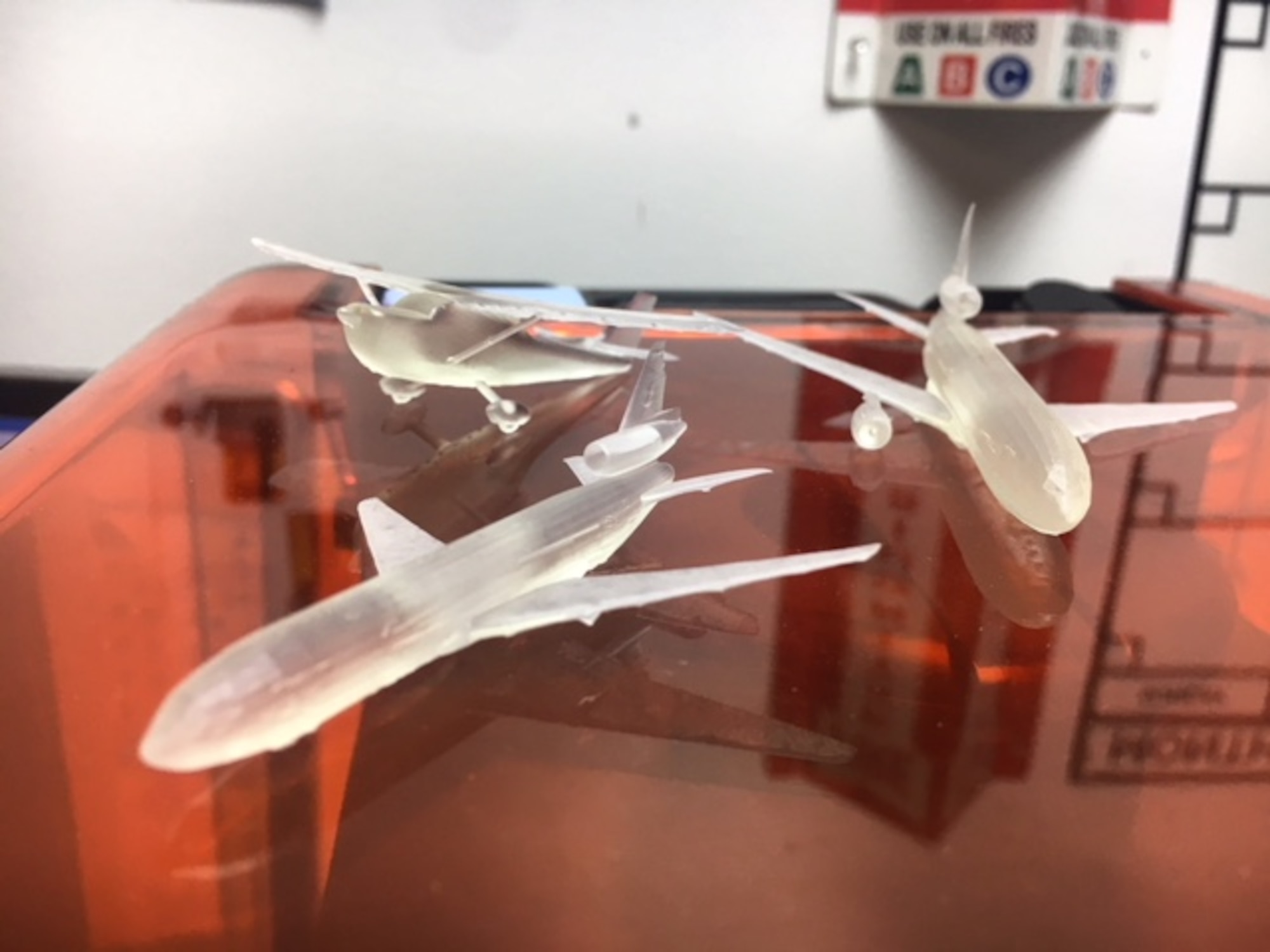 Miniature enamel figures of aircraft are displayed to illustrate the fine detail that can be produced by Travis Air Force Base, California's, Phoenix Spark's 3-D printer, Jan. 19, 2018. The 3-D printer has applications beyond producing aircraft figures including fabricating aircraft machinery parts and medical prostheses. (U.S. Air Force photo by Airman 1st Class Christian Conrad)