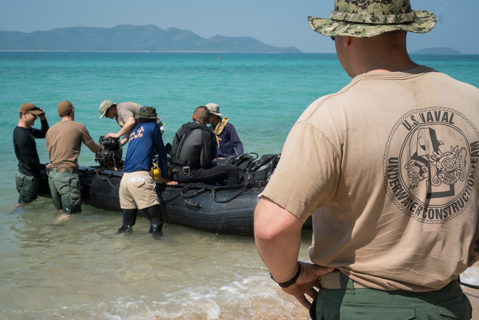 Construction Mechanic 1st Class Matt Ramirez, assigned to Underwater Construction Team (UCT) 2, observes as UCT 2 Sailors prepare to dive with Republic of Korea and Royal Thai Navy in Sattahip, Thailand during Exercise Cobra Gold Feb. 14, 2018. The 37th iteration of Cobra Gold is an important element of the United States and participating nations seeking to maintain readiness, develop capabilities, and enhance security and stability.