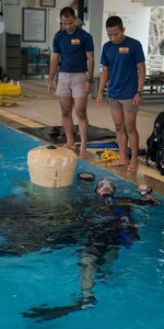 Royal Thai Navy sailors assist U.S. Navy Diver 1st Class John Reinemund, assigned to Mobile Diving and Salvage Unit 1, as he maneuvers a lift bag in the RTN Dive School pool in Sattahip, Thailand for Exercise Cobra Gold Feb. 19, 2018. Cobra Gold 18 provides a venue for the United States, allied and partner nations to advance interoperability and increase partner capacity in planning and executing complex and realistic multinational force and combined task force operations.