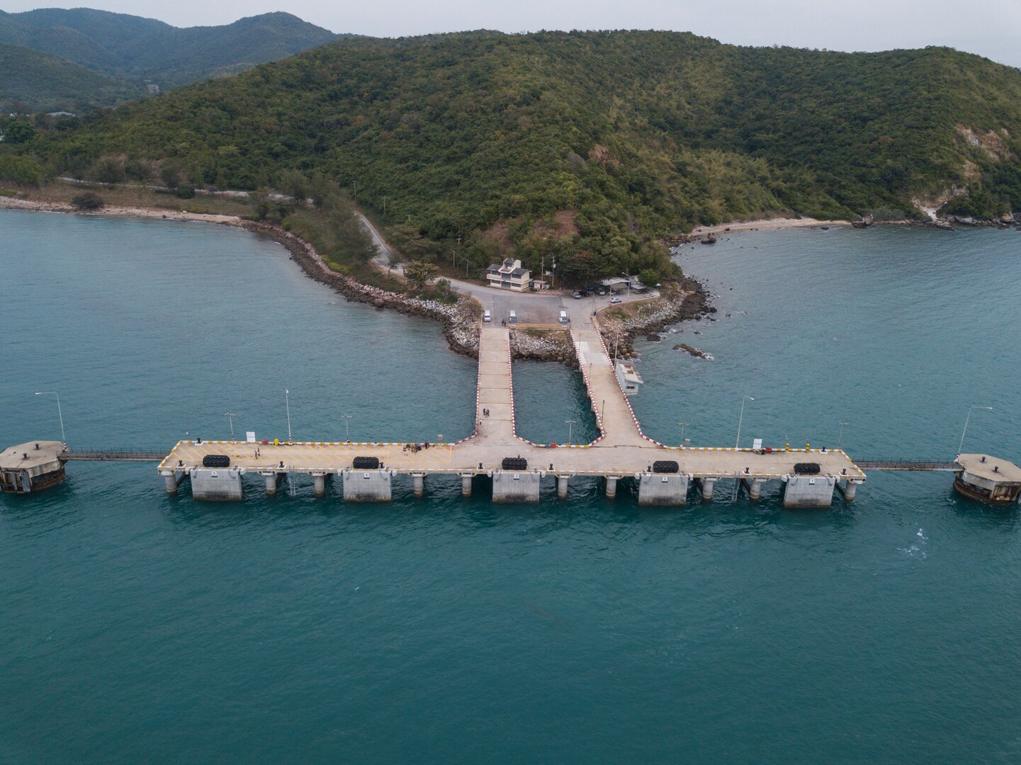 U.S. Navy Sailors assigned to Underwater Construction Team 2, stand on the Thung Prong Pier in Sattahip, Thailand during Exercise Cobra Gold Feb. 19, 2018. Cobra Gold 18 provides a venue for the United States, allied and partner nations to advance interoperability and increase partner capacity in planning and executing complex and realistic multinational force and combined task force operations.