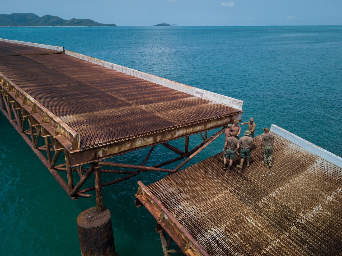 U.S. Navy Sailors assigned to Underwater Construction Team 2 stand on the De Long Pier in Sattahip, Kingdom of Thailand during Exercise Cobra Gold Feb. 20, 2018. Cobra Gold 18 provides a venue for the United States, allied and partner nations to advance interoperability and increase partner capacity in planning and executing complex and realistic multinational force and combined task force operations.
