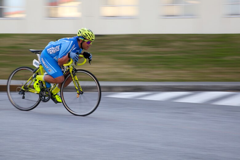 A racer coasts down a hill during a bike race Feb. 18 aboard Camp Kinser, Okinawa, Japan. The several loop course allowed racers to push themselves uphill and catch their breath on the downhill. The race brought U.S. and local communities across Okinawa together to take part in friendly competition. (U.S. Marine Corps photo by Pfc. Nicole Rogge)