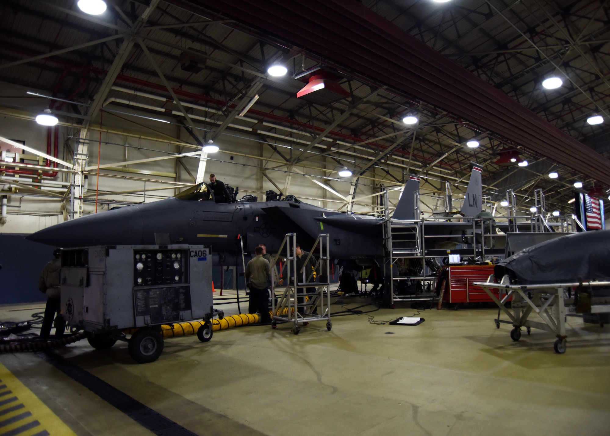 48th Equipment Maintenance Squadron Airmen inspect an F-15E Strike Eagle during a phase inspection at Royal Air Force Lakenheath, England, Feb. 14. During the inspection, a team of crew chiefs take apart the F-15 in order to complete a more comprehensive check of the aircraft. (U.S. Air Force photo/Senior Airman Abby L. Finkel)