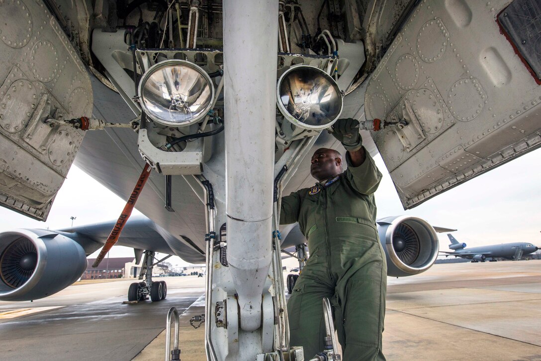 Air Force Master Sgt. Greg L. Thomas inspects the KC-10 Extender aircraft landing gear.