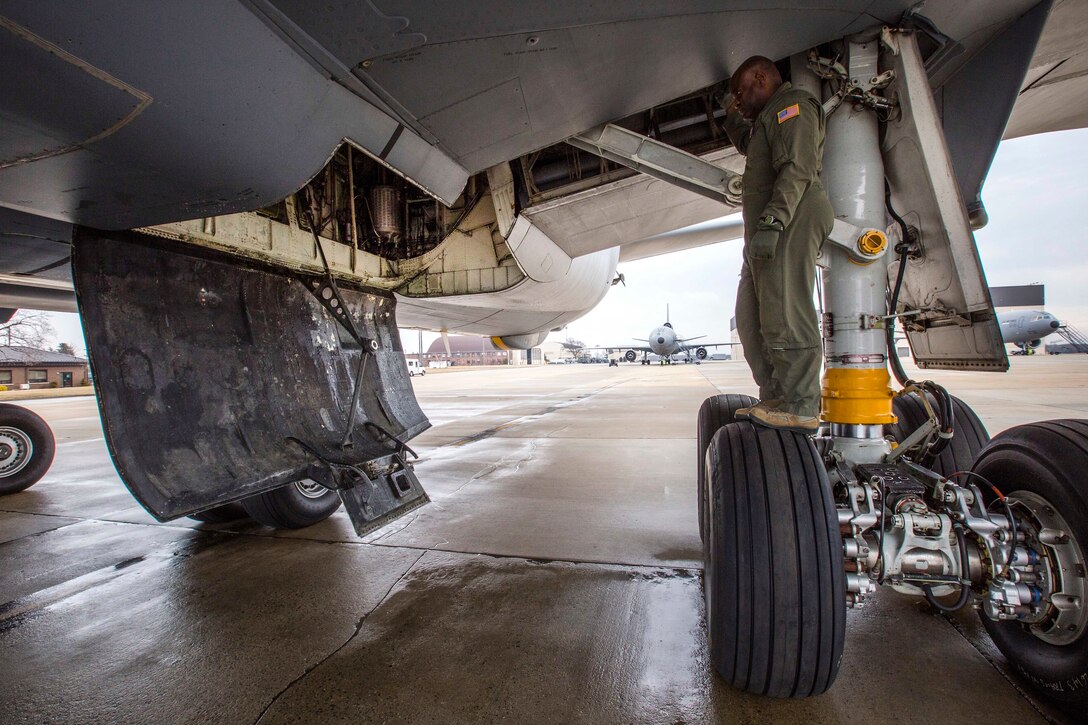 Air Force Master Sgt. Greg L. Thomas inspects the KC-10 Extender aircraft landing gear.