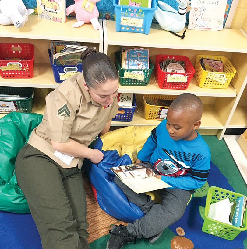 Cpl. Kayla Soles reads to a child at Triangle Elementary School as part of Marine Corps Base Quantico's Adopt-A-School program.