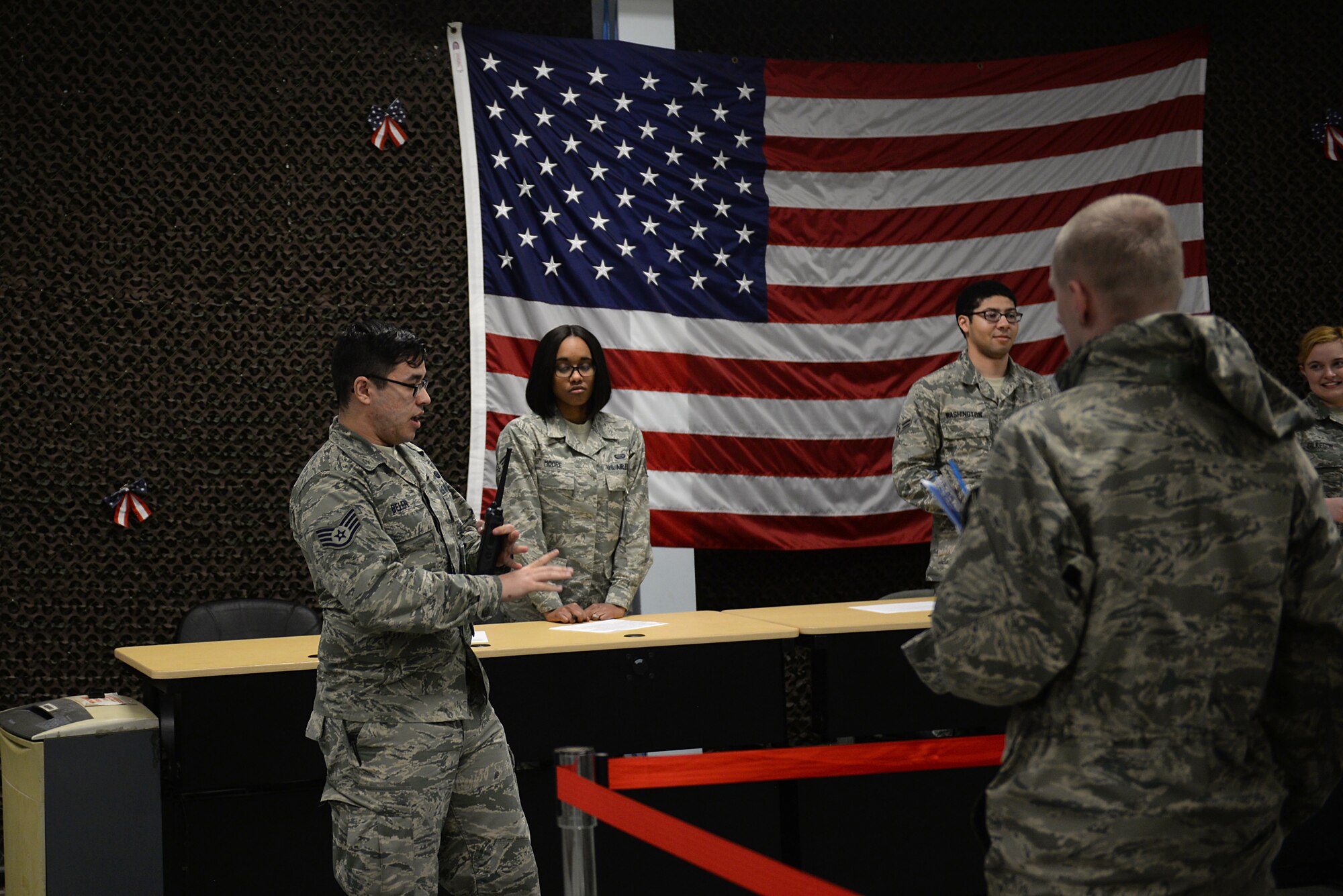 A staff sergeant in an Air Force Battle Uniform talks to a group of Airmen.