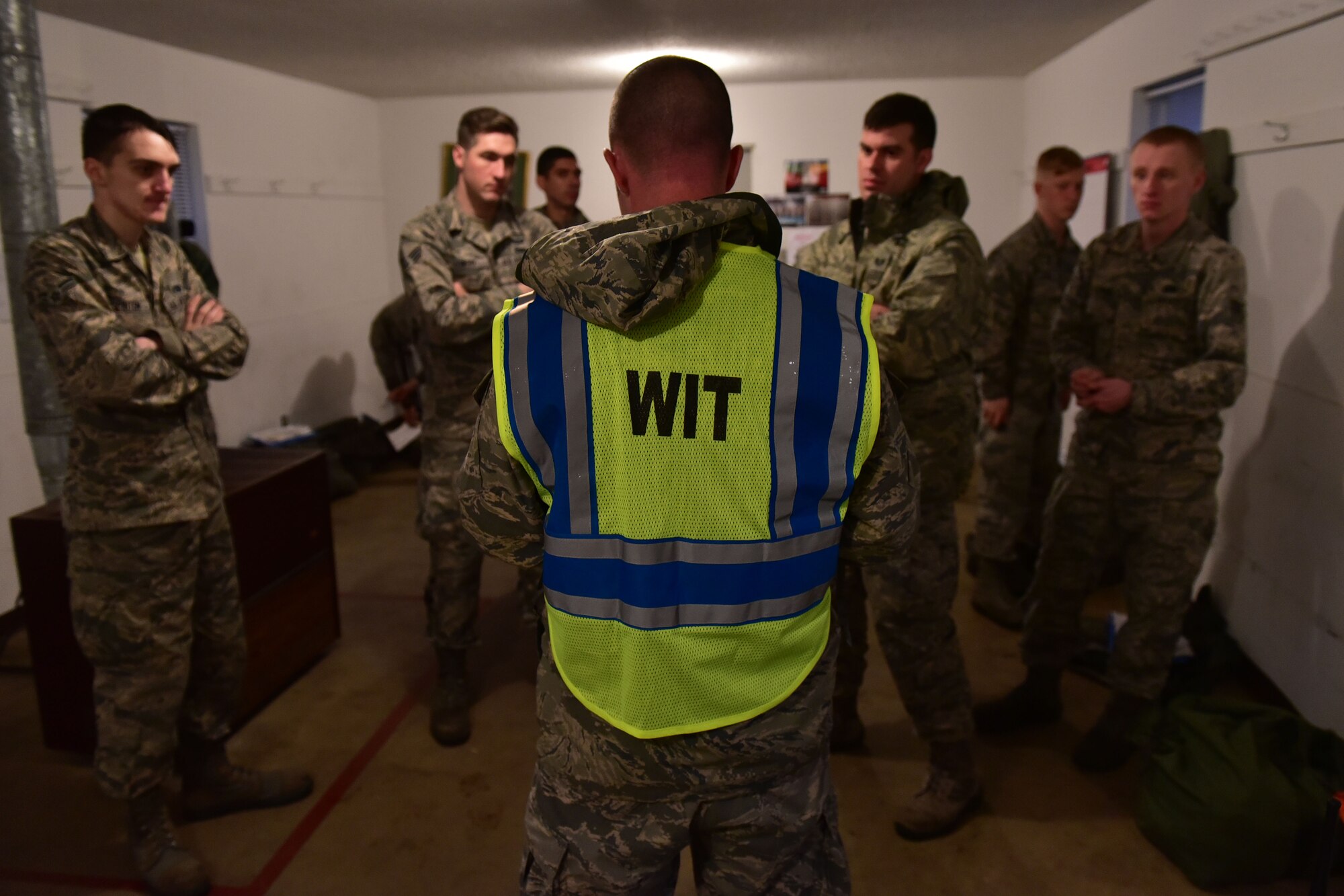 Man stands in front of four other men.